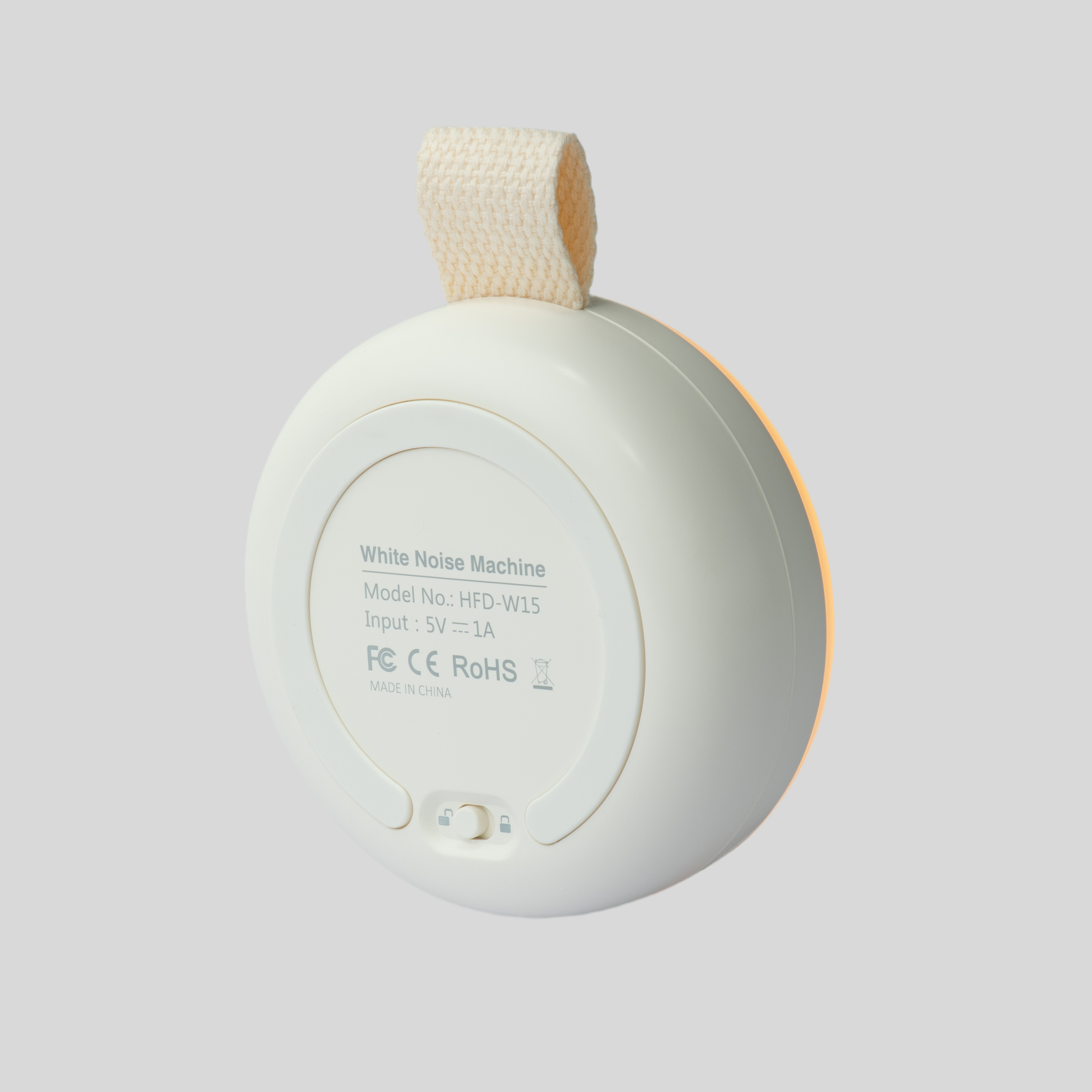 White portable baby white noise machine and night light in packaging.