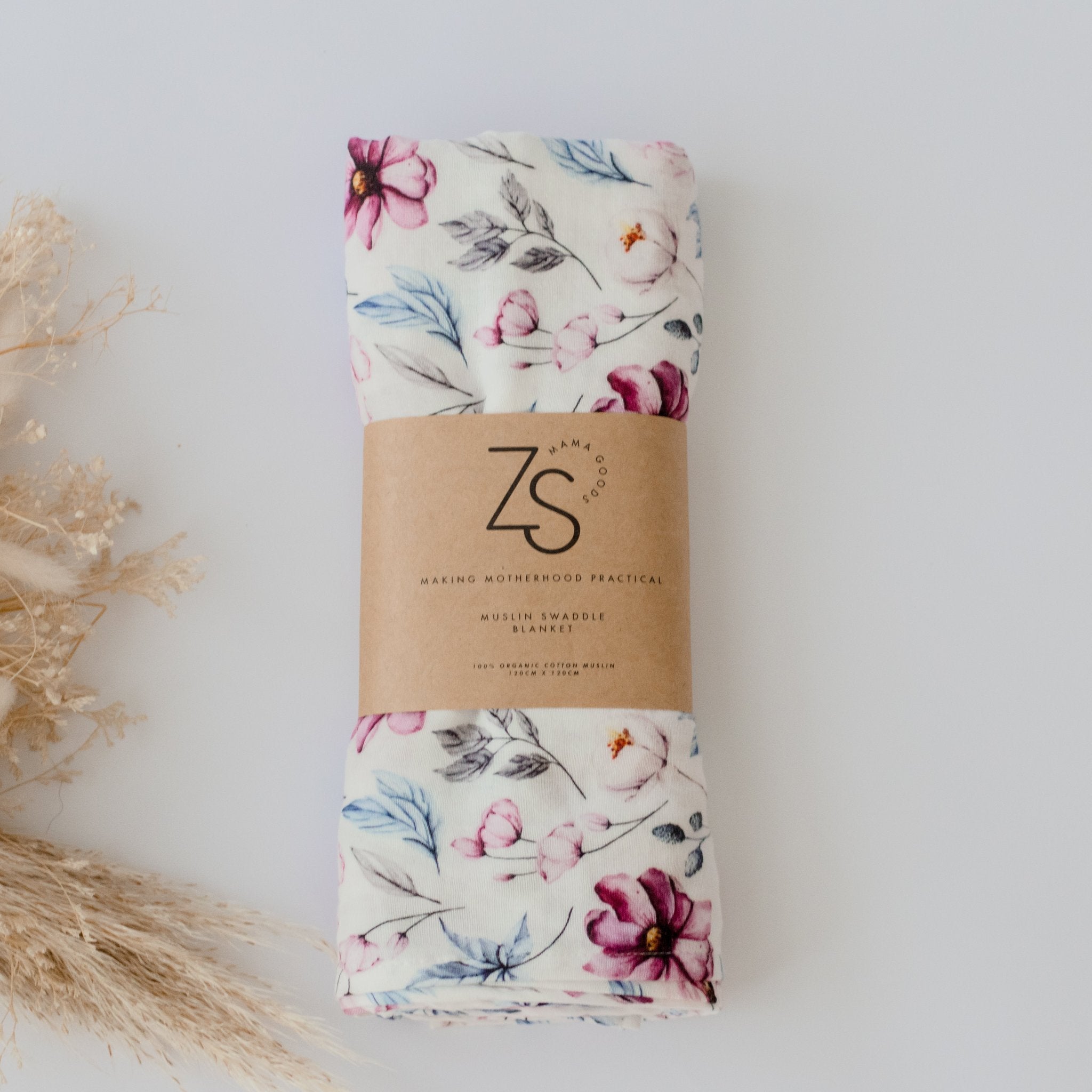Organic cotton muslin swaddle wrap in soft floral petals design by Zoe Sage.