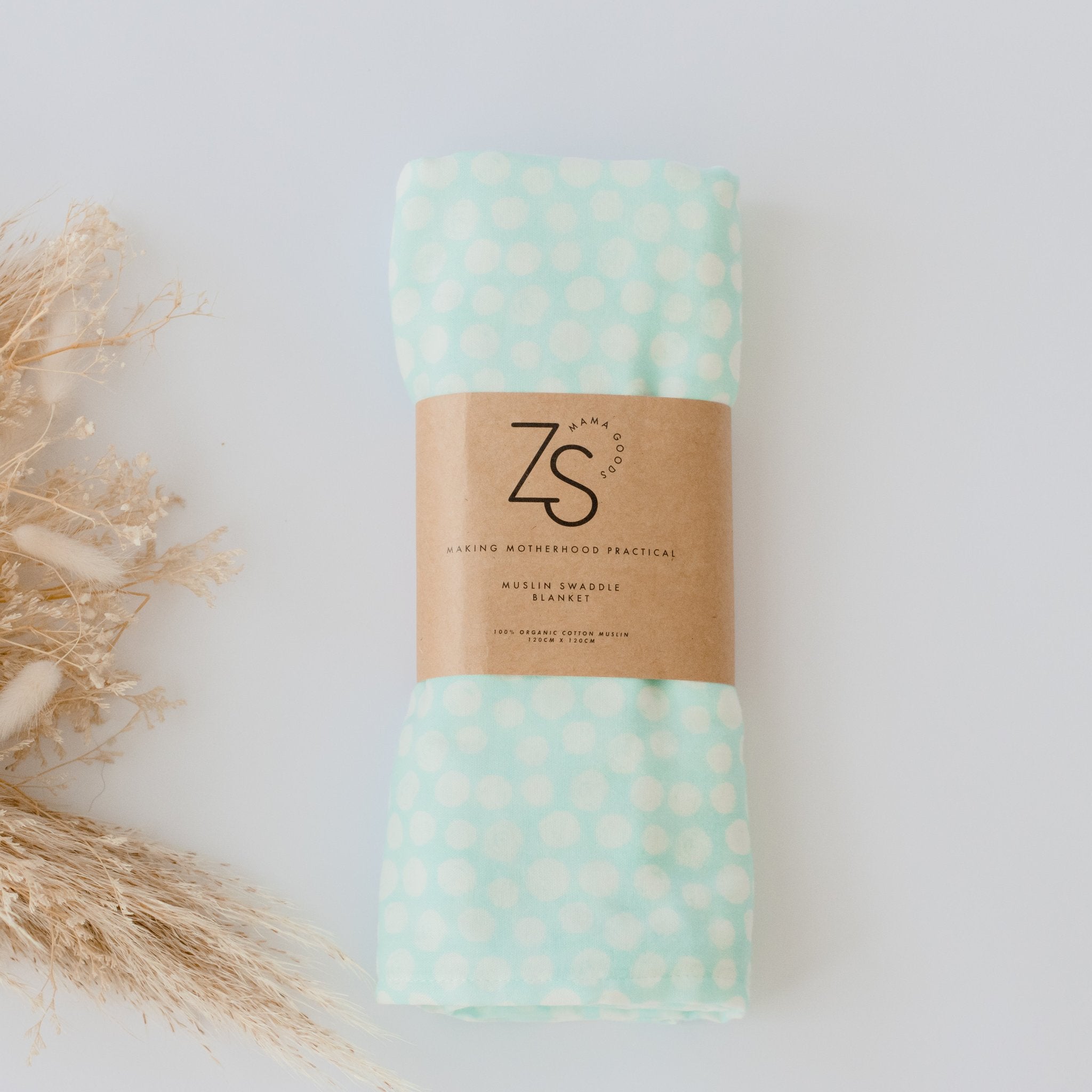 Organic cotton muslin swaddle wrap in mint whirl colour by Zoe Sage