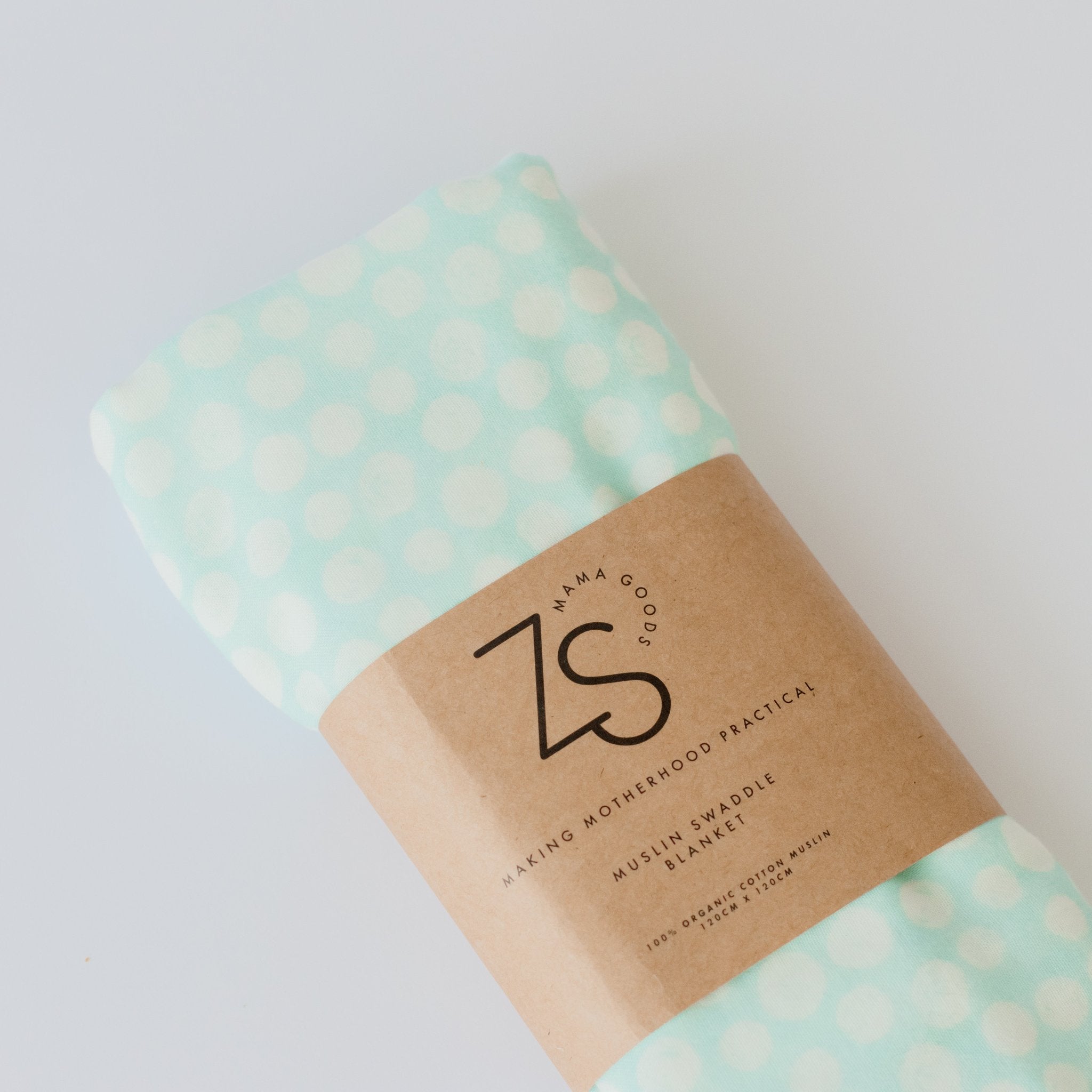 Soft organic cotton muslin swaddle wrap in mint green folded neatly