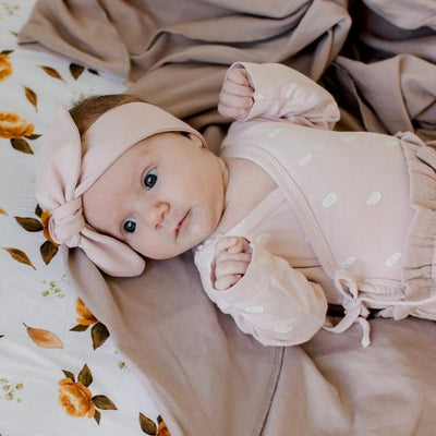 Blush baby top knot headband flat lay displayed by Zoe Sage
