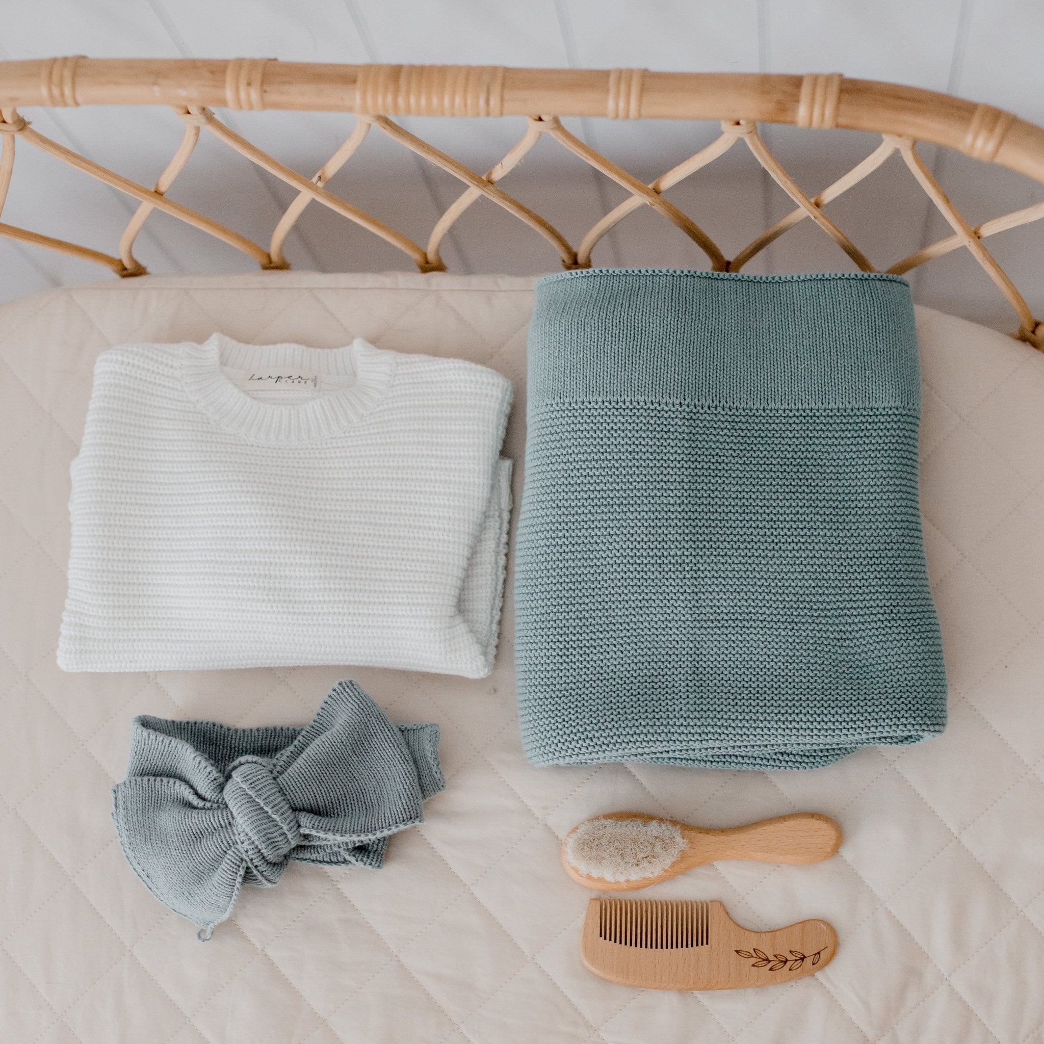 Mantis green baby blanket and topknot set bundled together in sustainable packaging.