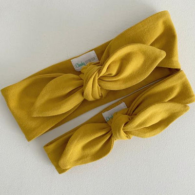 Mustard yellow baby top knot headband flat lay by Zoe Sage