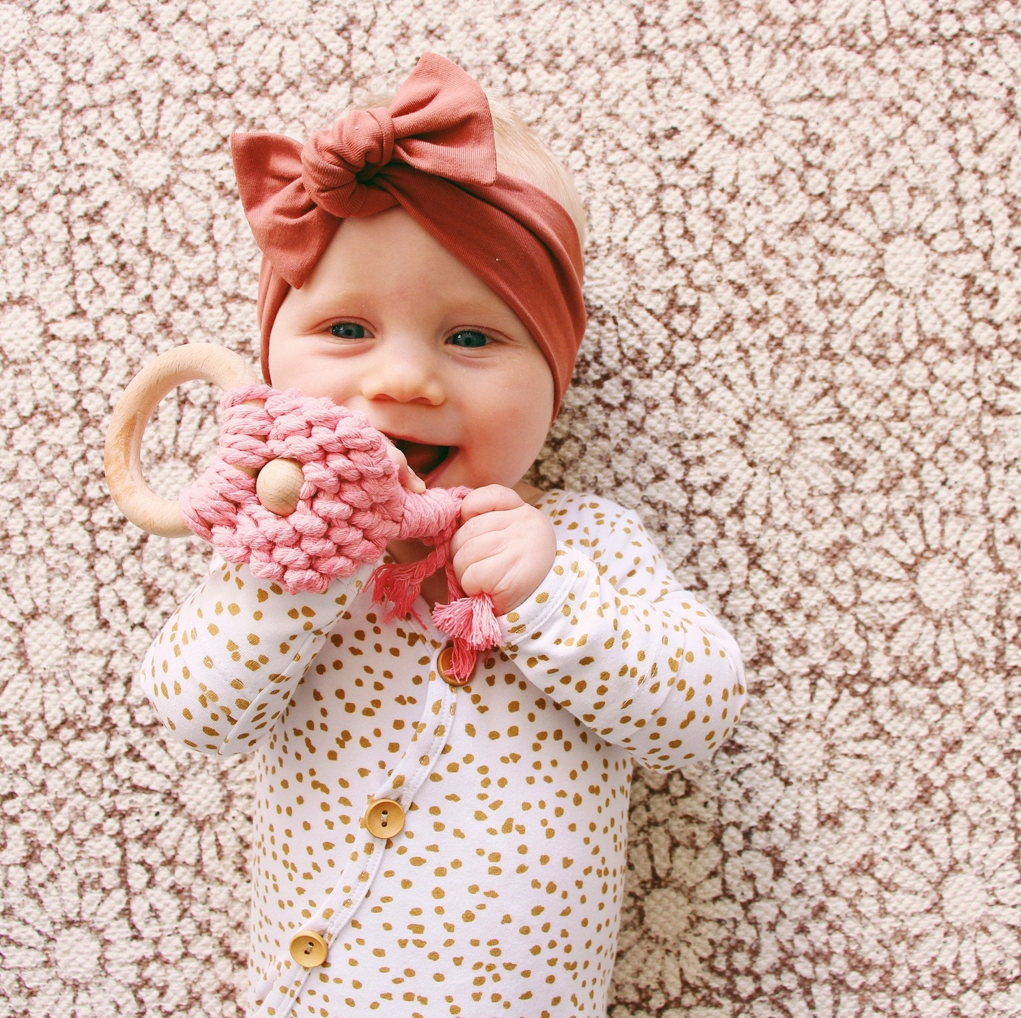 Rust coloured baby bow knot headband styled on infant
