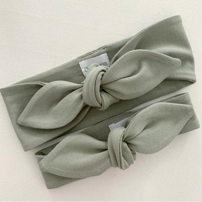 Sage green baby top knot headband flat lay on white background by Zoe Sage