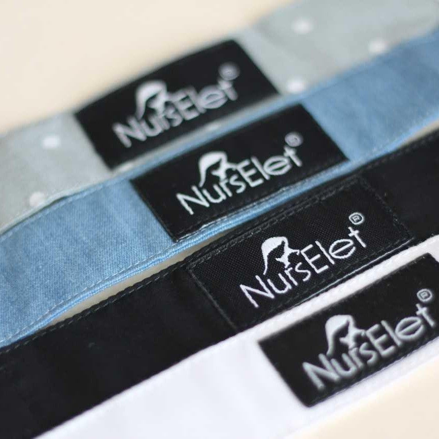 Wooden nursing bracelet in soft neutral tones for tracking feeding sessions
