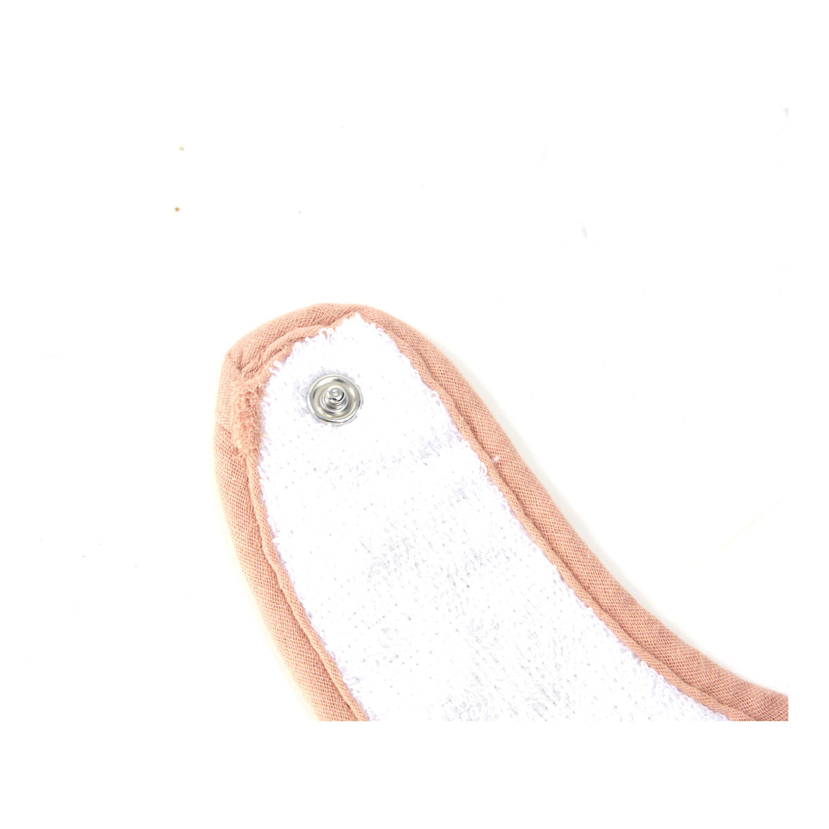 Close up of the press stud fastening on a Zoe Sage muslin baby bib
