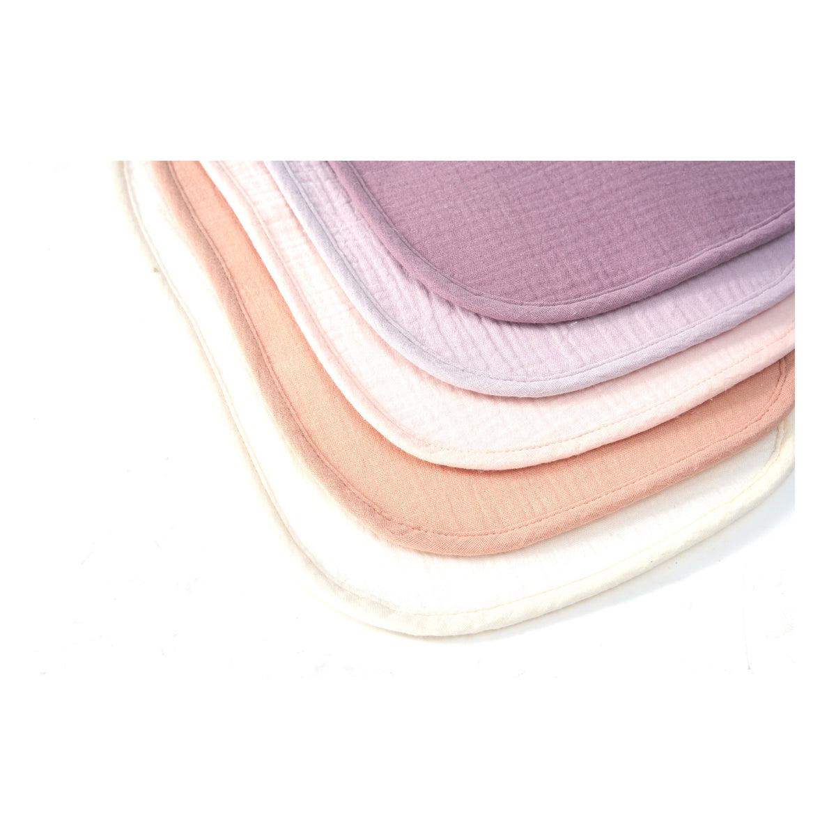 Stacked organic muslin baby bibs in Lavender Blush colours, close up of the weave