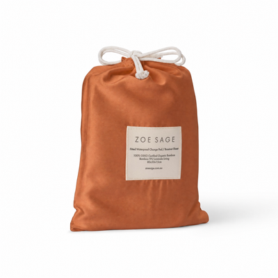Savannah Rust waterproof bassinet sheet and change pad cover in its drawstring storage bag, Zoe Sage