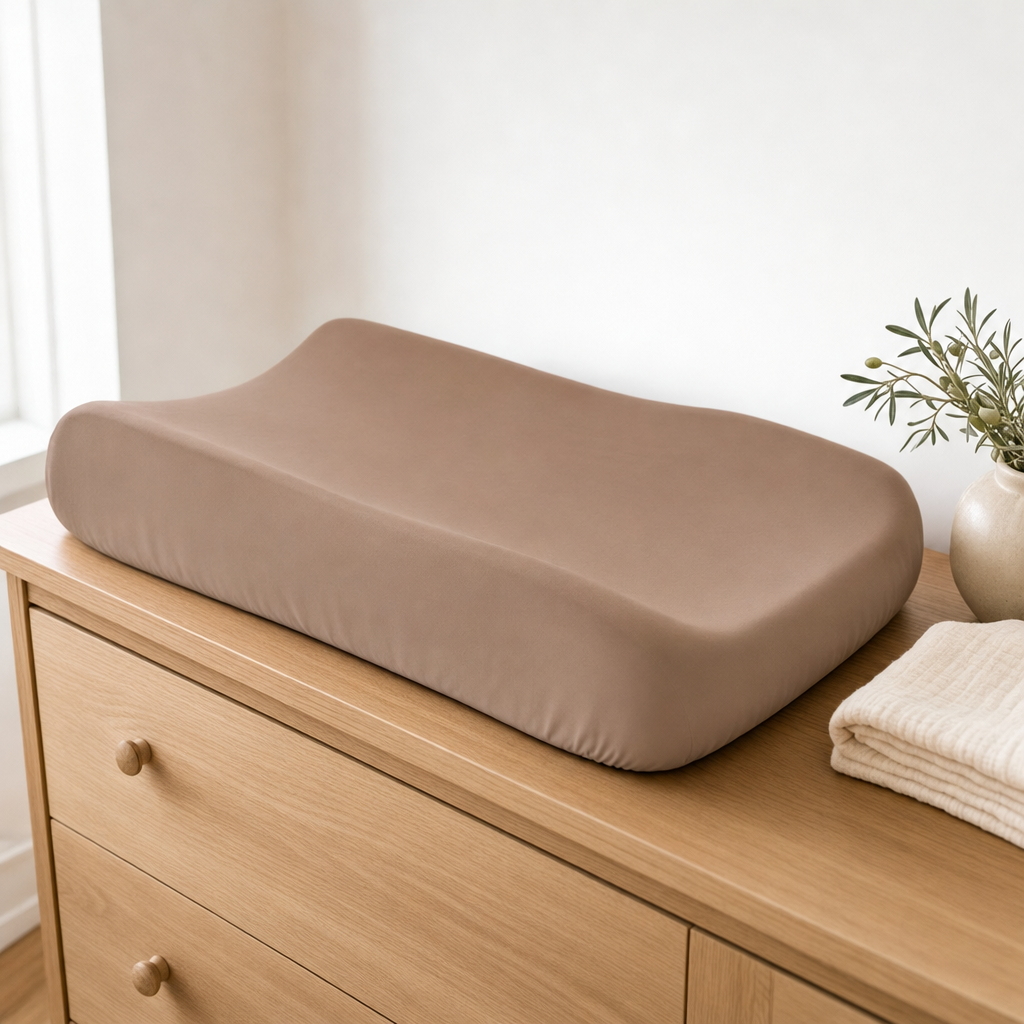 Mocha waterproof bassinet sheet used as a change pad cover on a nursery dresser