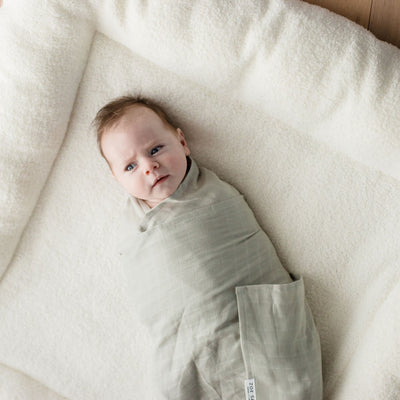 Sage green organic cotton muslin swaddle wrap by Zoe Sage