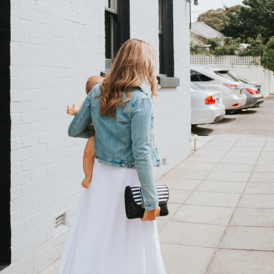 Women with her baby showing Nappy Change Mat Clutch | Zebra Crossing