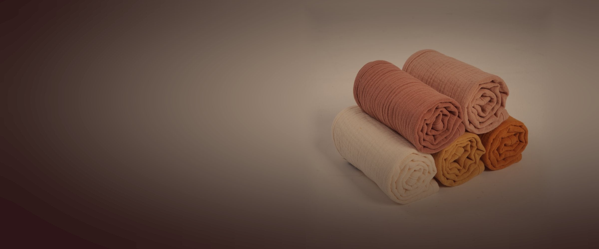 Zoe Sage organic muslin burp cloths, lit by a night light